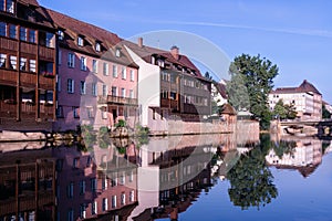 A number of houses stand on the banks of the Pegnitz River in Nuremberg Germany