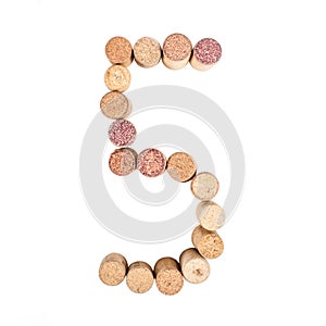 The number 5 is made from wine corks, close-up. Isolated on white background