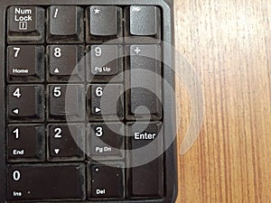 Number  The number keys on a computer keyboard on the wooden table background