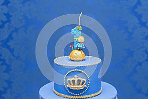 Number one candle on a blue background. Little prince theme. Fake birthday cake with personalized candle for first birthday for