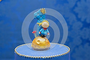 Number one candle on a blue background. Little prince theme. Fake birthday cake with personalized candle for first birthday for