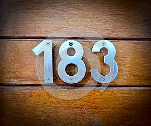 183, number 183 on a wooden background, house number, home number, numbres