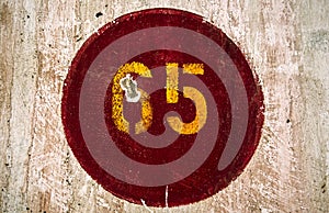 Number 65 painted in a wall of an old train station photo