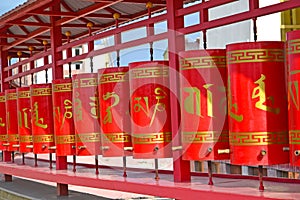 A number of prayer drums in the Buddhist complex `Golden Monastery of Buddha Shakyamuni.` Elista, Kalmykia. Tibetan text