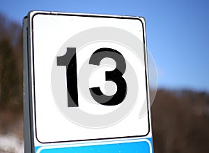 Number 13 in a road sign in mountain photo