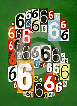 Number Six made from numbers cutting from magazines on green background