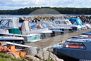 A number of small boats moored in the small harbor on the Baltic sea