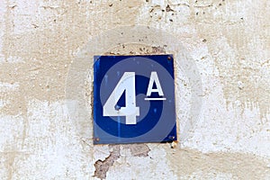 number 4 on a stone  white wall