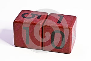 Number ten written on a red wooden cube of a calendar date