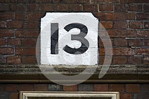 Number thirteen hand painted on plaster background