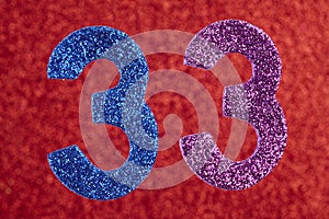 Number thirty-three blue purple color over a red background