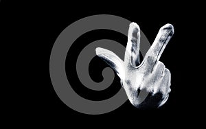 Number three 3 - a male hand wearing white glove isolated on black background. Hand gestures