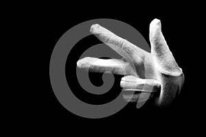 Number three 3 - a male hand wearing white glove isolated on black background. Hand gestures