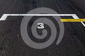 Number three position ranking close up on racing asphalt track