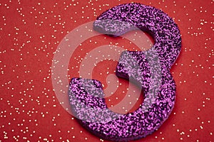 Number three purple color over a red background. Anniversary