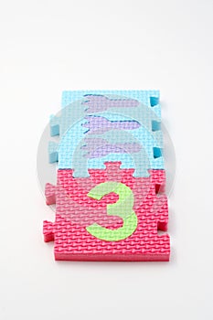 Number three puzzle mats. Focus on the front (small DOF)