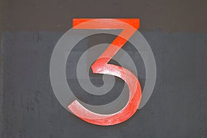 The number three on a concrete background