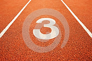 Number three on running track