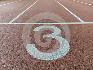 Number three third 3 on the start of a running track - check my portfolio for other numbers