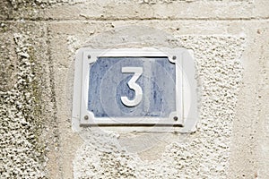 Number three on the wall of a house