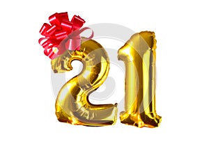 Number twenty one of golden helium balloons with red bow, on white background