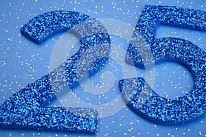Number twentyfive blue color over a blue background. Anniversary