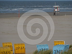 Numbered booths and the lifeguard tower on the Juist island beach, Germany