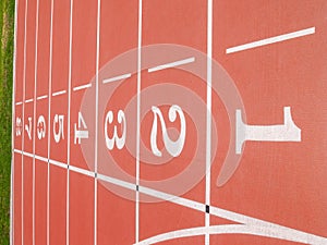 Numbered lanes on red running track