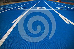 Numbered running track blue color. Starting position.