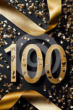 The numbers 100 in beautiful gold and black, gold ribbon, 100 celebration.