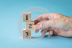 Numbers 123 on wooden cubes standing on top of each other