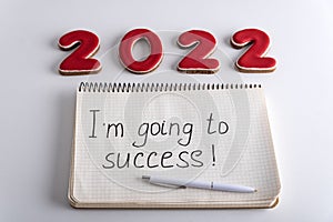 Numbers 2022 and notebook with the words I am going to success. Motivation for 2022