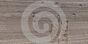 numbers 2024 and start on gravel road from above on surface with car tire tracks in countryside