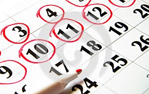 The numbers on the calendar are circled in red in macro. Calendar for plans, notes, meetings. Business calendar. Marker for notes