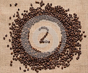 Numbers from coffee beans on burlap background