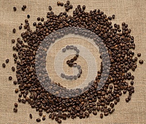 Numbers from coffee beans on burlap background
