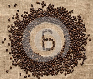 Numbers from coffee beans on burlap background