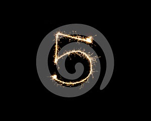Numbers 5 or five Sparkler firework light isolated on black background