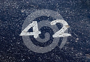 Numbers painted on concrete and asphalt surfaces