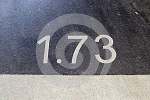 Numbers painted on concrete and asphalt surfaces