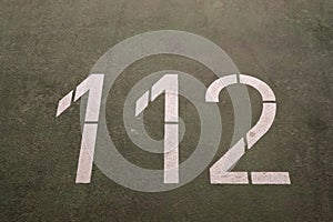 Numbers painted on concrete and asphalt surfaces