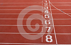 Numbers on red running track.