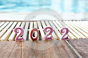 2022. Numbers on side of pool. New Year at resort, traveling. TURISM concept photo