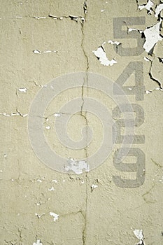 Numbers stencilled on old wall background