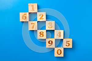 Numbers. Wooden colorful alphabet blocks on blue background, flat lay, top view.