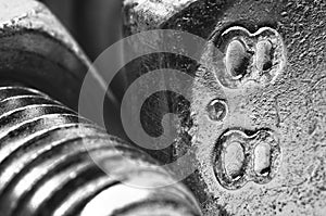 Numbers written on a bolt head. black and white macro photography