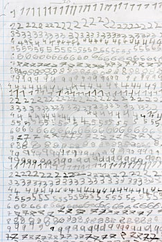 Numbers written by a child repeated on the sheet of paper notebook at school