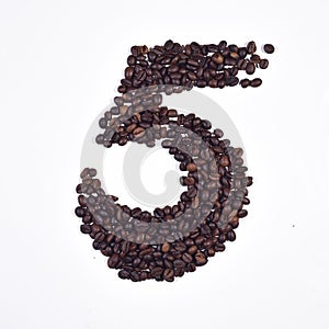 Numeral 5 from coffee beans, isolated on white background