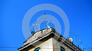 Numerous antennas and TV dishes on an ancient building, typical of many Italian cities.