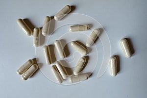 Numerous beige capsules of Saccharomyces boulardii probiotic from above